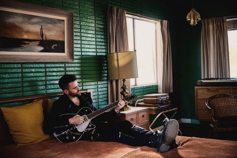 Gareth Emery playing guitar at Four Aces Movie Set in California