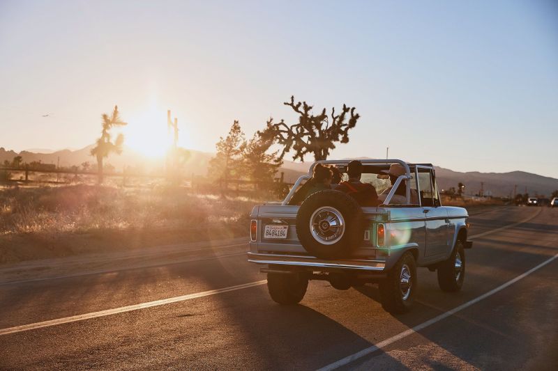Sunset with a vintage blue  Ford Bronco in the California Desert