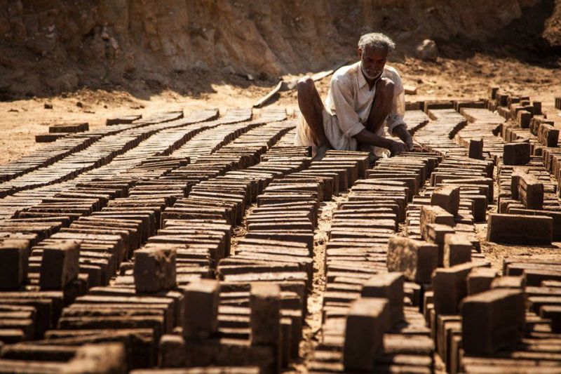 Making clay bricks in Rajasthan, father and daughter