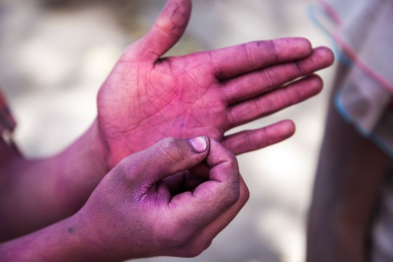 Holi festival in Rajasthan, painted hand asking for money