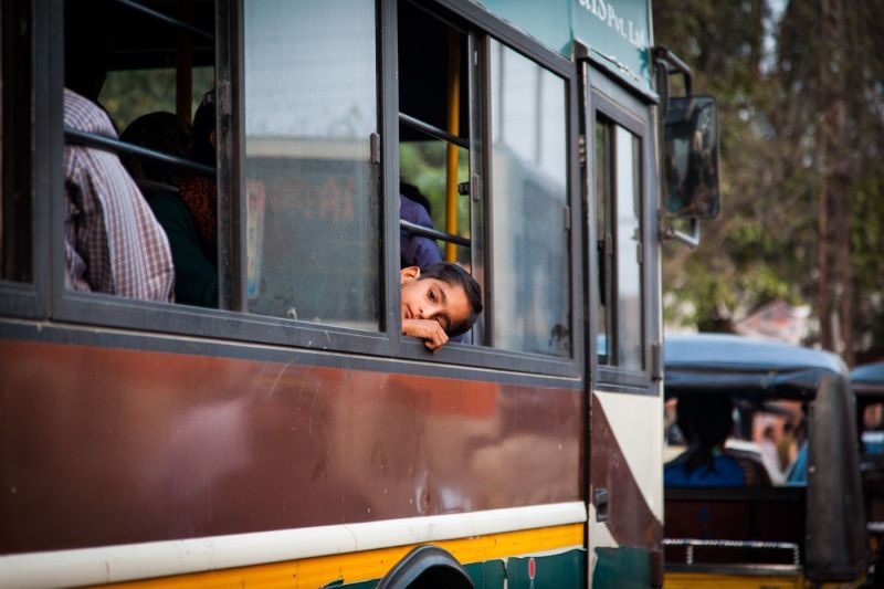 Indian boy on a bus, leaning at the window, Rajasthan