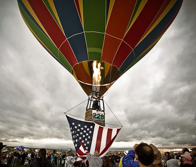 First balloon with American flag taking off at the Albuquerque Balloon fiesta