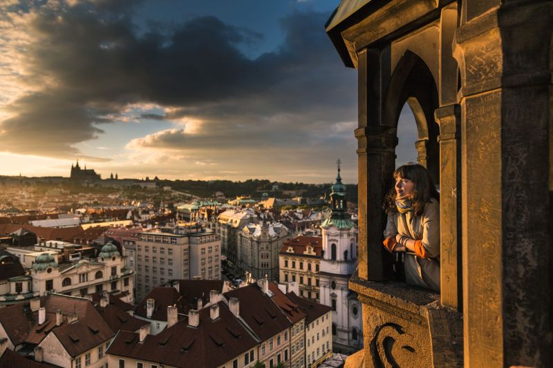 Praha, Staroměstské náměstí with girl looking at Old town at sunset