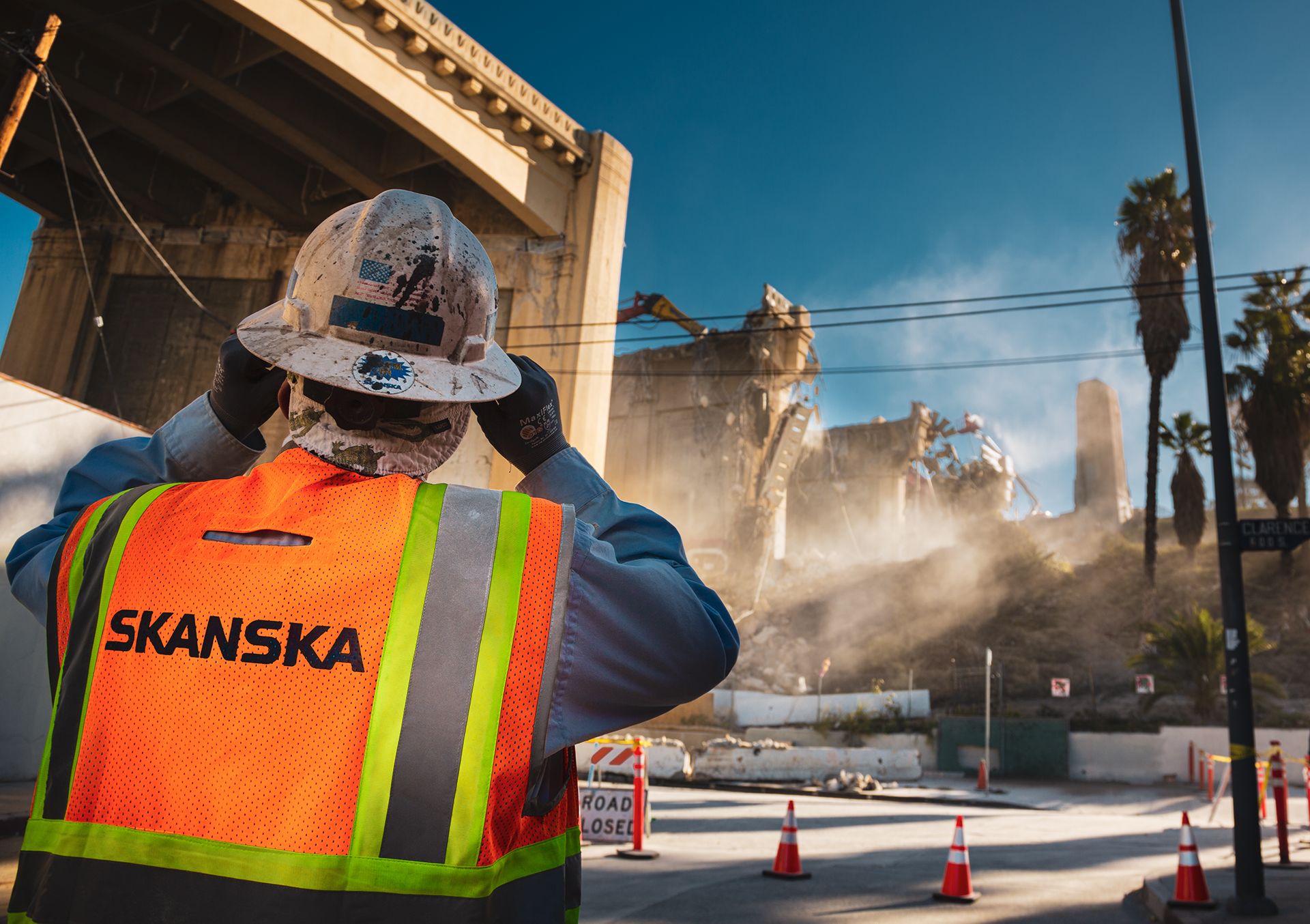 Worker supervising the demolition of the Sixth Bridge acqueduct in Downtown Los Angels during the first day