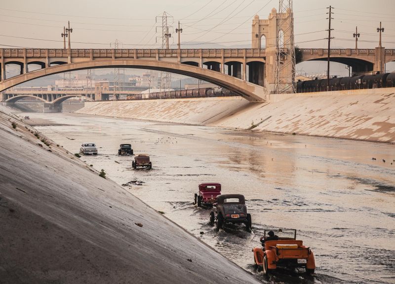 Los Angeles river with vintage cars riding on the riverbed