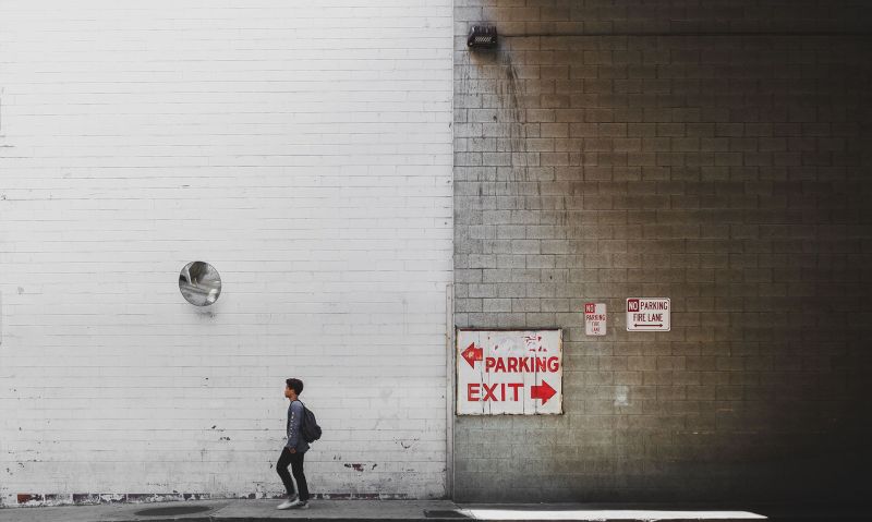 Direction in Downtown Los Angeles, wall with person walking on the street and street sign