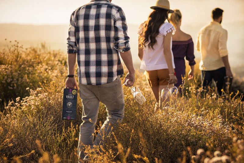 Wine in a box lifestyle scene with friends walking in a beautiful outdoor scene
